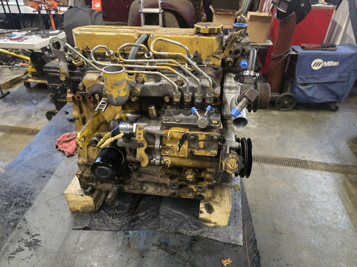 CAT diesel engine removed from a machine and mounted on a shop bench for hydraulic and engine repair work